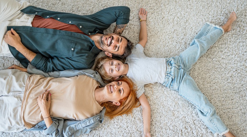Happy parents and little daughter at home